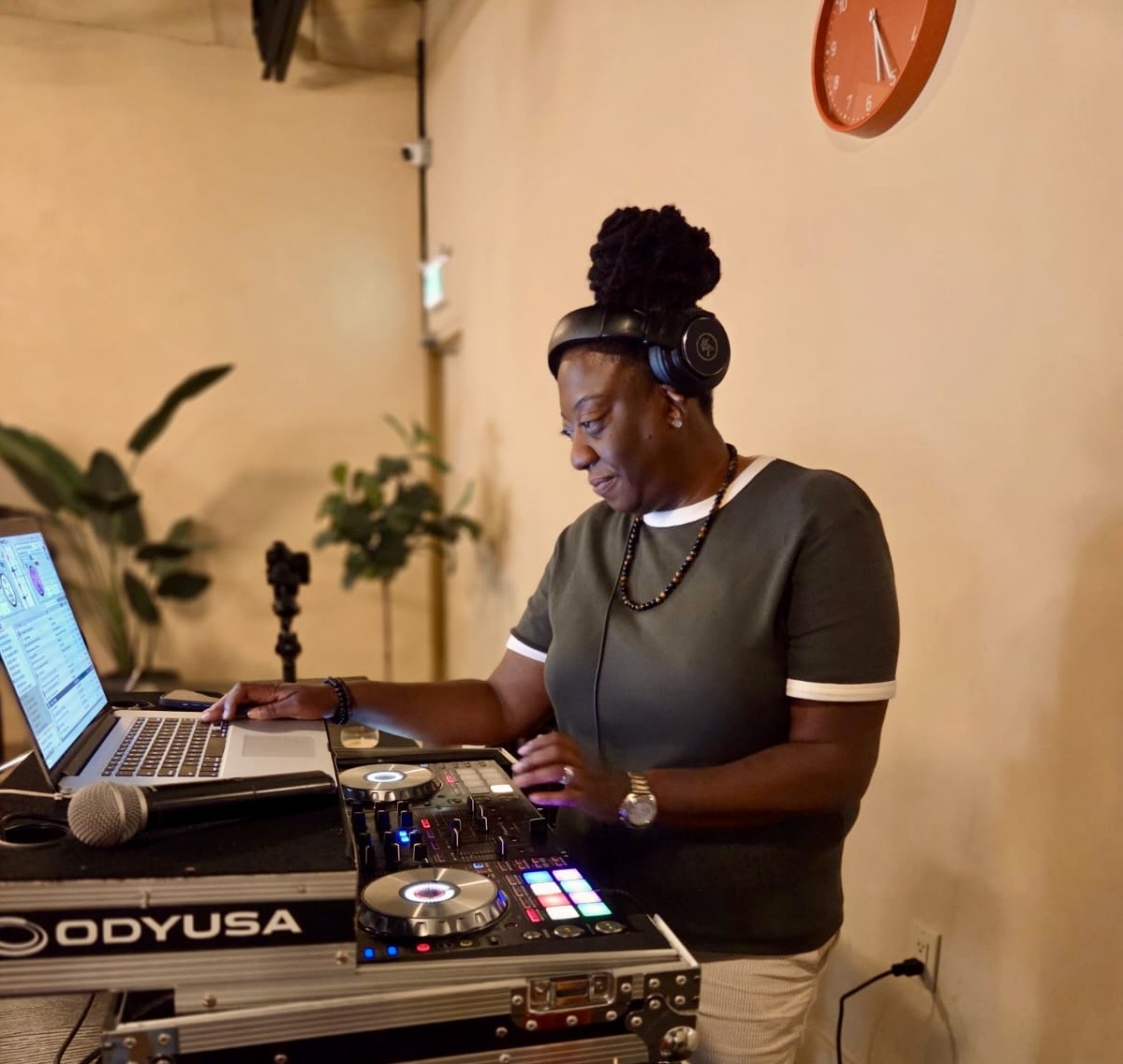 DJ JJ Rock wearing headphones while performing at her laptop and controller