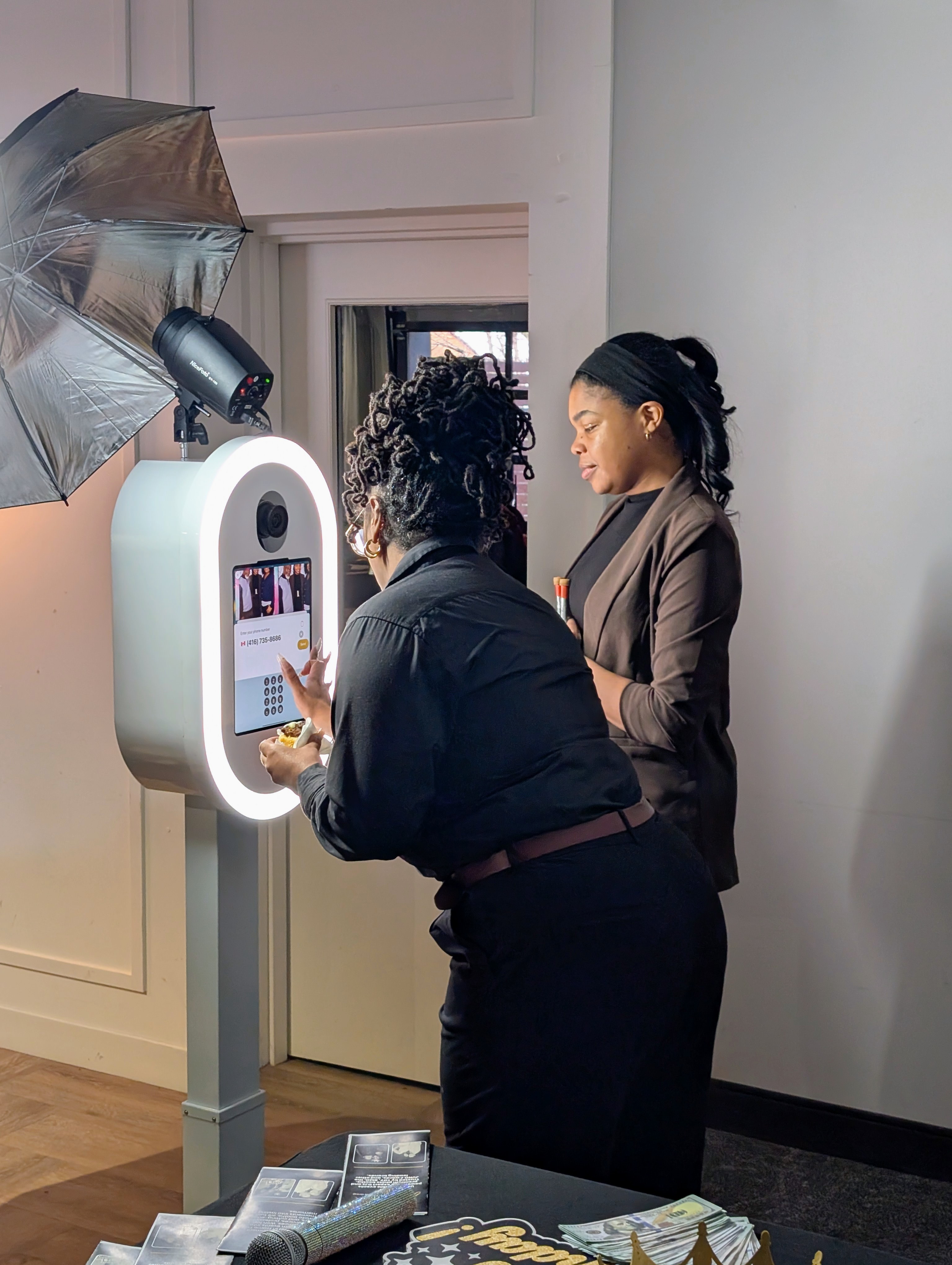 Guests using an InFrame photo booth with an attendant